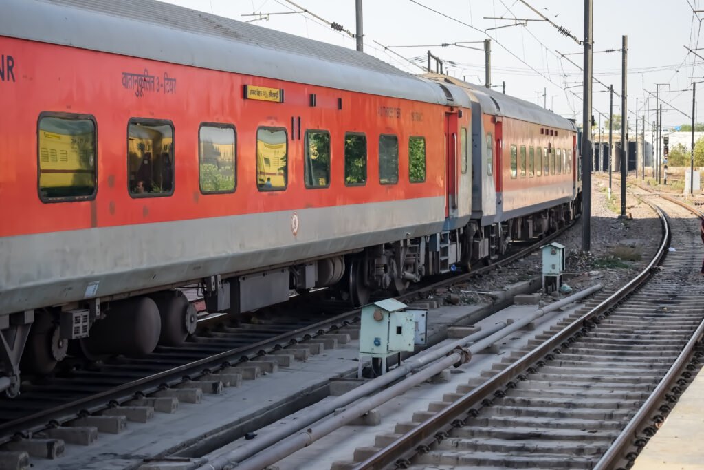 delhi, india, june 09 2024 indian railway express train at departure from anand vihar railway station during morning time, colourful express train at delhi railway station